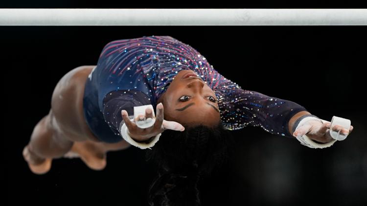 Simone Biles is on the Olympic gymnastics competition floor in front of a star studded crowd