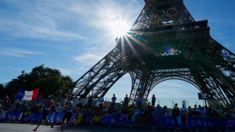 A man is seen climbing the Eiffel Tower prompting an evacuation hours before closing ceremony