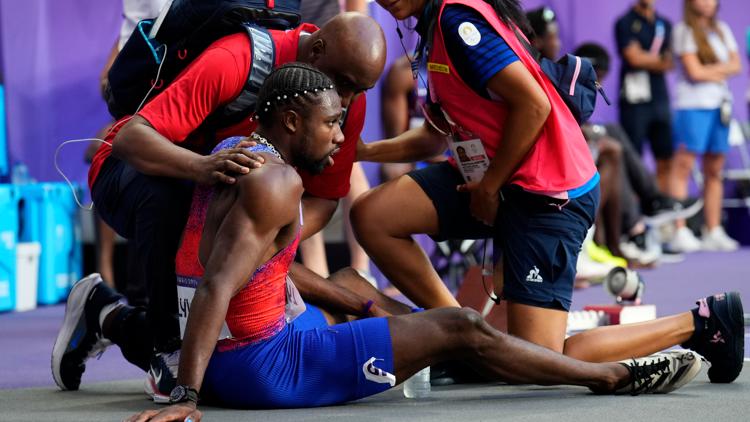 Medics tend to Noah Lyles cart him away from track after mens 200 final