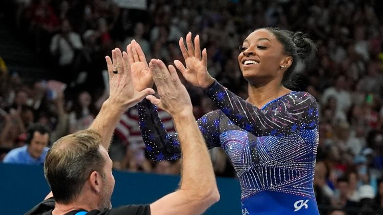 Why do Team USA gymnasts wear different color leotards in the same event